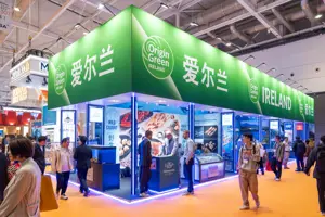 Trade Show in Asia with green Ireland branding and passersby in the foreground