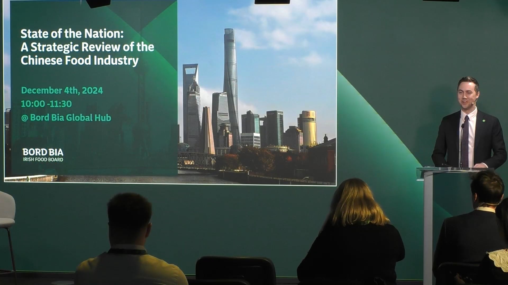 Welcome address with speaker at podium on stage