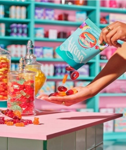 A person pouring candy into a hand

Description automatically generated