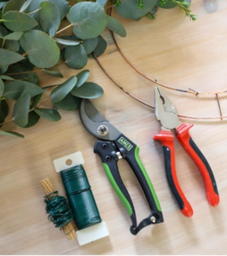 garden tools and wire on wooden table 