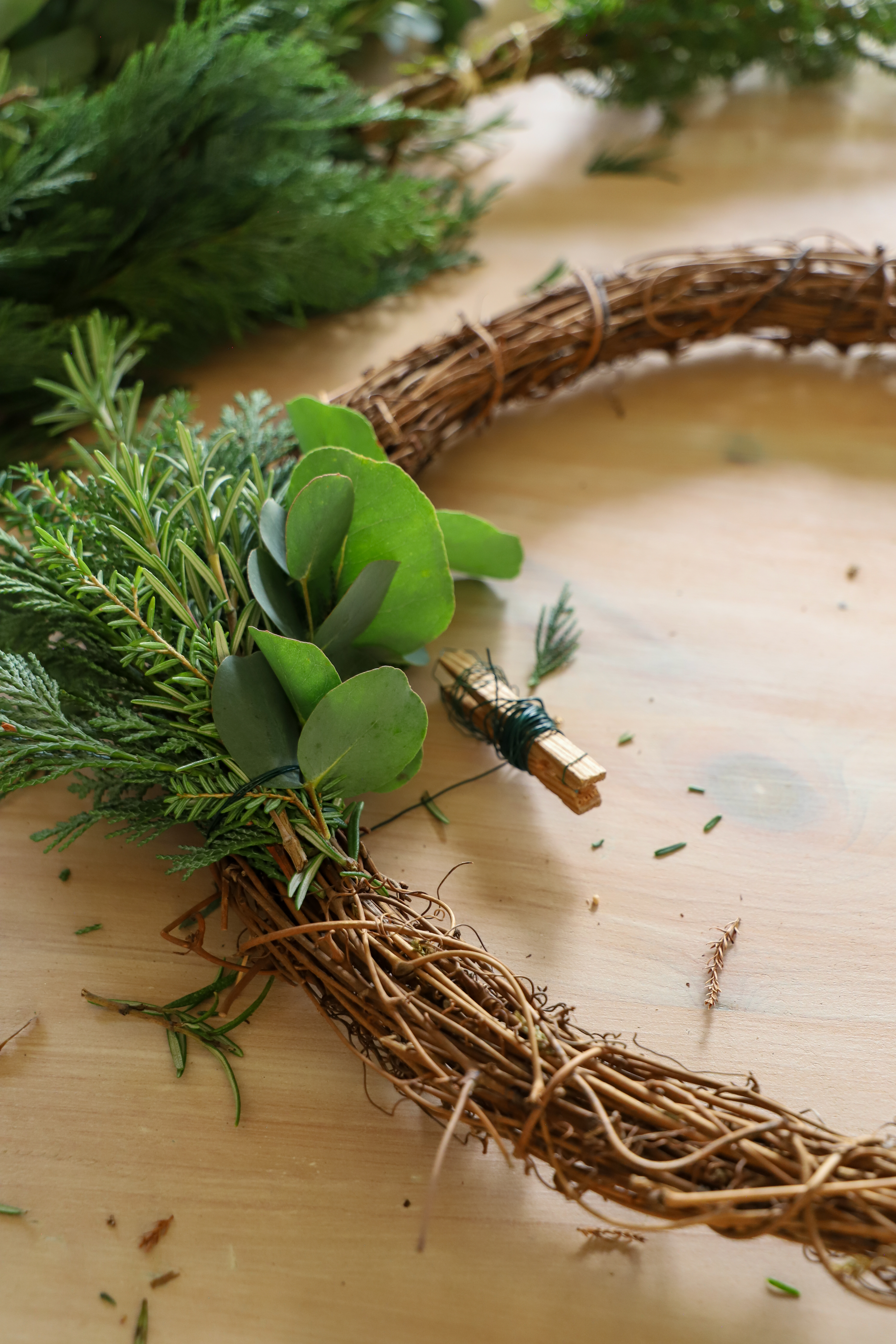Green foliage pinned to stick base 