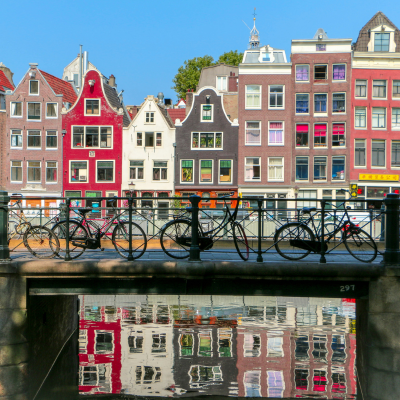 Image of a bridge in an Amsterdam canal with bikes alonside the ridge