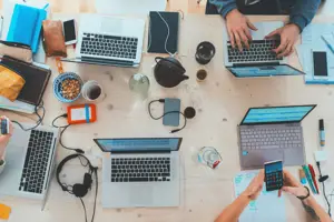 Aerial view of laptops and hands