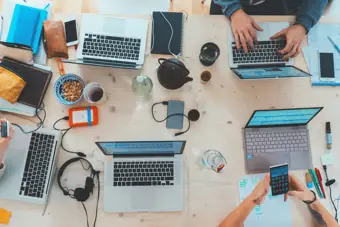 Aerial view of laptops and hands