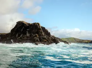 Rocky outcrop surrounded by choppy waters
