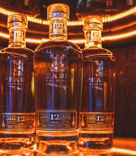 Three whiskey bottles with Pearse Lyons Distillery logo
