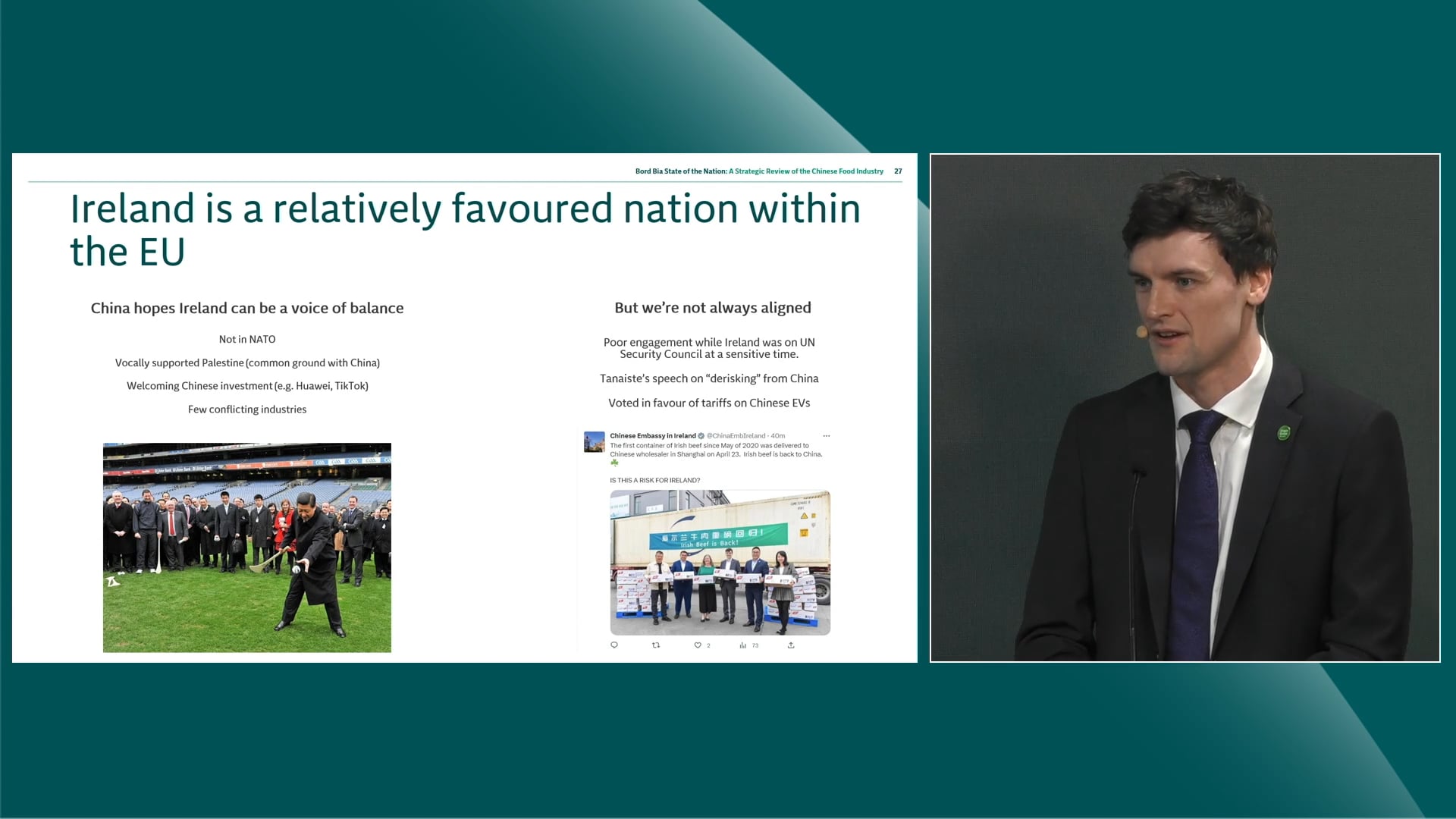 Speaker on stage going through slides on presentation