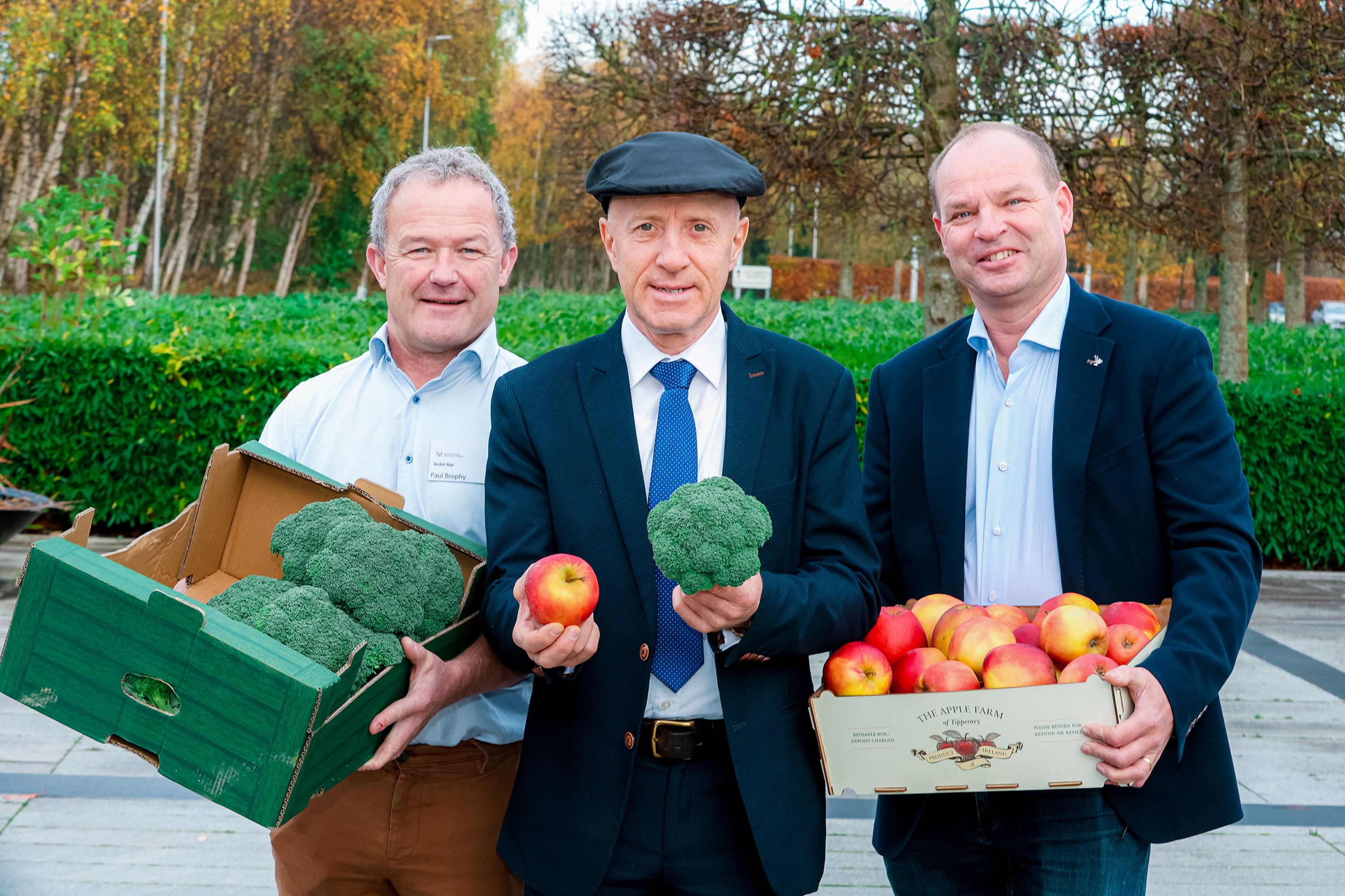 Minister Healy Rae, Paul Brophy and Con Traas holding broccoli and apples